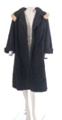 A black Astrakhan wool coat by Dickens & Jones , Regent Street,