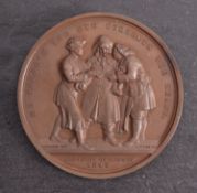 An Art Union of London 1848 bronze Hogarth medal (54mm), with old paper spink envelope.