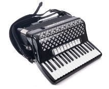 An Excelsior piano accordion, black and silver in flight case.