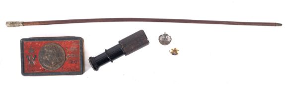 A Victorian Boer War chocolate tin, two military badges,