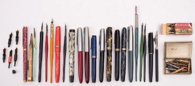 A collection of various fountain pens, including a gold and brown marbled Swan pen, a Parker 61,