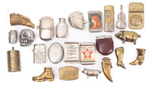 A collection of twenty-two various brass and silver plated novelty and advertising vesta cases,