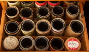 A collection of approximately 104 Indestructible cylinders in a wooden chest