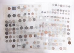 A collection of World coins on sheets with banknotes.