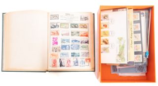 A stamp album and contents plus a box of FDCs.