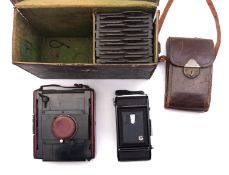 A Goerz Ango Folding Strut Quarter plate camera in red leather finish,
