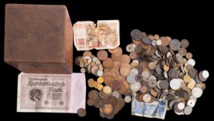 An old cigar box containing mixed European and world coins in old bank packets.