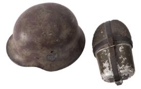 A German M1942 pattern Stalhelm, green and brown camouflage with decal to one side,