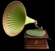 A Columbia oak cased table top gramophone, with moulded tin horn over painted in green and gold.