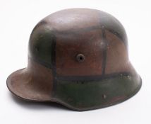 A WWI period German M1916 Stahlhelm, hand painted camouflage finish with brown leather liner,