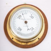 A brass bulkhead barometer, maker Kelvin Bottomley & Baird Ltd, Glasgow,