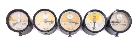 A group of five brown Bakelite signal repeaters.