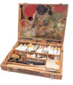 A Winsor & Newton paint box, containing two palettes and a collection of used oils and brushes.