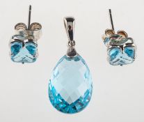 A blue topaz pendant and earrings, the pendant set with a teardrop shaped mixed-cut blue topaz,