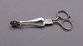 A pair of George III Provincial silver tea tongs makers mark only circa 1770,