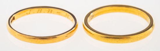 Two wedding bands, one with UK hallmark for 22ct gold, size N, and one indistinctly marked 22ct,
