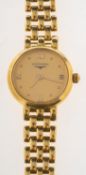 Longines an 18ct gold wristwatch the round dial having Roman and dot numerals,