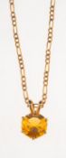 A fire opal pendant with chain, the pendant set with a circular-cut fire opal,