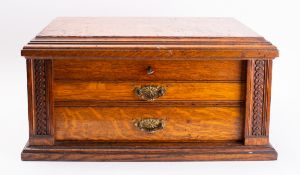 An early 20th century oak canteen case, hinged lid opens to reveal a fitted interior,