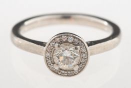 A diamond halo ring, set to the centre with a brilliant-cut diamond, diamond approx. 0.