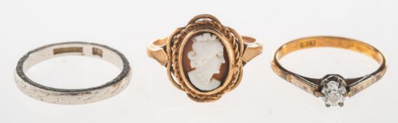 A group of three rings, including an engraved band, marked PLATINUM, size J1/2, 3.