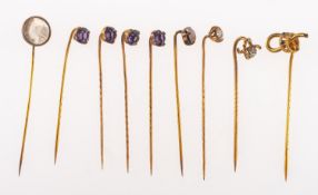 A collection of nine antique gilt stick pins,