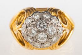 A modern diamond cluster ring, of bi-colour,