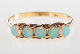 An antique five stone opal ring, claw set with five opal cabochons, indistinct mark, size L1/2 to M,