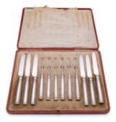 A cased set of twelve George V silver fruit knives and forks by Thomas Bradbury and Son, Sheffield,