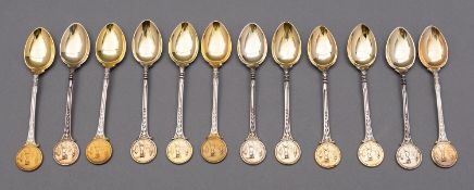 A mixed group of silver parcel gilt golfing trophy teaspoons, various dates, by Walker and Hall,
