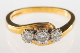 An 18ct gold three stone diamond ring,
