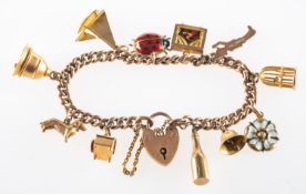 A charm bracelet with charms, the charm bracelet having a heart padlock and safety chain,