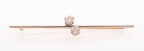 A 'Toi et Moi' diamond bar brooch, off set to the centre with two old-cut diamonds, diamonds approx.