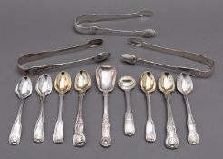 A matched set of Victorian Kings and Queens pattern flatware including; three pairs of sugar tongs,