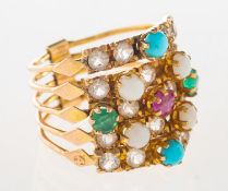 A gem-set stacking ring, five articulated stacking rings, joined to verso by a solid bar,