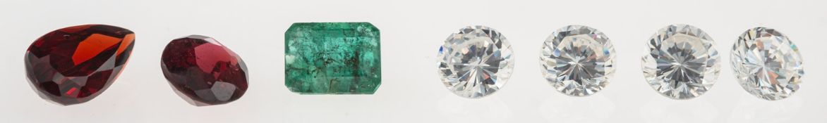 A group of seven loose semi-precious gemstones & paste stones to include: A loose oval-cut garnet,