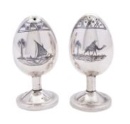 A pair of mid 20th century Iraqi silver salt and pepper, not marked, of egg shape,