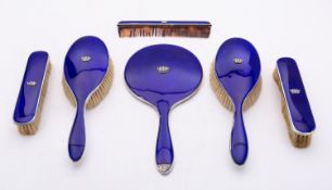 A George V six piece silver and enamel dressing table set in a fitted case by Adie Brothers Ltd,