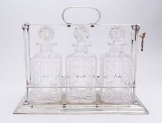 A George V silver plated three bottle tantalus by Hukin & Heath, model number 1560 H & H mark,