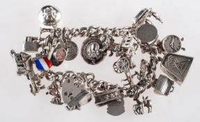 A silver charm bracelet with charms, of curb links with heart padlock and safety chain,