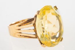 A 9ct gold cocktail ring, claw set with an oval mixed-cut lime green stone,