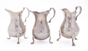 A mixed group of silver including; three mid 20th century cream jugs of baluster form,