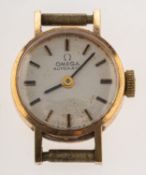 Omega a lady's gold wristwatch the round silvered dial having raised baton numerals,