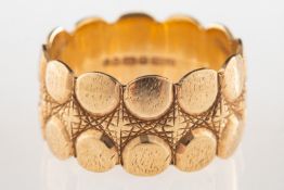 A 9ct gold wide textured ring, UK hallmark, size R, 6.1grams.