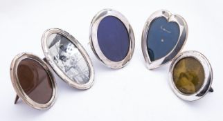 A group of silver photograph frames including;