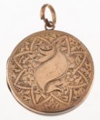 A circular locket, with foliate and floral engraving, unmarked, diameter approx. 3.0cm, 6.5grams.