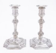 A pair of Edward VII Britannia standard cast silver candlesticks by Lambert & Co, London 1908,
