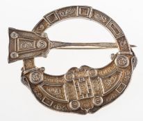 A silver replica of the Scottish Hunterston Brooch,