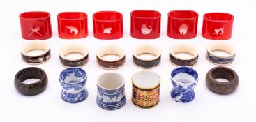 A set of six 20th century Orrefors cased red glass napkin rings etched with animals,