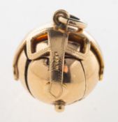 A Masonic ball pendant, opening to reveal engraved Masonic symbols in a cruciform design,